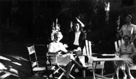 Women sitting in lawn chairs at 5575 Angus Avenue