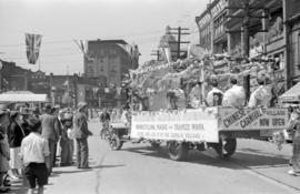 [A float of acrobats in a parade in Chinatown]