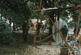 View of sculpture area with Kiyoshi Takahashi and his sculpture in foreground, sheltered by awning