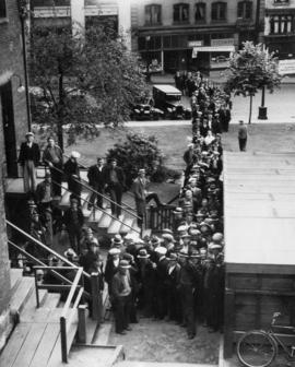 Men waiting in food line