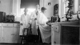 [Mrs. Cox, Dr. H.H. Pitts and Joe Garner working in a laboratory at Vancouver General Hospital]