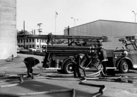 Daily routine drill [view of firefighters checking hoses]