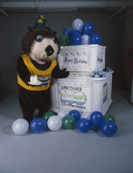 Tillicum standing beside large birthday cake