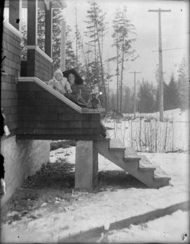 Mrs. Evelyn Salter holding Phyllis on porch of North Vancouver home