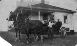 Mr. Duncan McRae and family in a hired horse and buggy in front of caretaker's bungalow at Little...