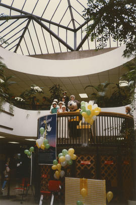 Tillicum walking down stairs with a group of people in white hats