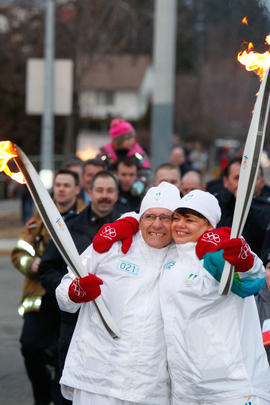 Day 89 Torchbearer 21 Gerry Zimmermann (L) hugs Torchbearer 22 Nioni Mattioda (R) after passing t...