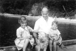 Jane Banfield, W.O. Banfield, and John Banfield with dog on dock