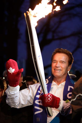 Day 106 Torchbearer 18 Arnold Schwarzenegger carries the flame in Stanley Park, British Columbia.