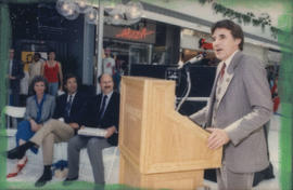 Unidentified man speaking from podium