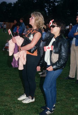 Two women watching a performance during the Centennial Commission's Canada Day celebrations