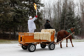 NEW-Day 34 Torchbearer 81 Martin Cloutier is carrying the flame in a Horse Carriage in  Chambord,...