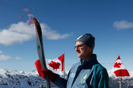 Torchbearer 8 Sascha Williams carries the flame in Whistler, BC