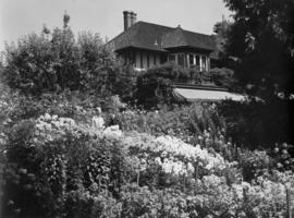 A man and a woman standing in the garden by the Murrin's home