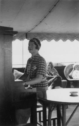 A woman playing the piano aboard the Vencedor