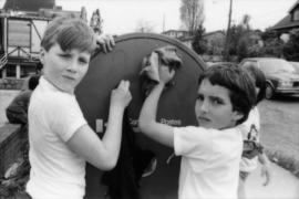 Troy Zwolinski and David LeBrun clean graffiti off mailbox