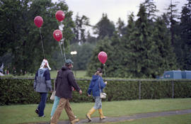 Group holding red balloons