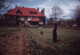 Antoinette Bentley and dog in garden at 1402 McRae Avenue