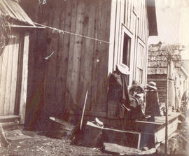 [First Nations children on porch]