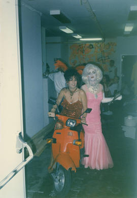 Adrian and unidentified person posing on a scooter