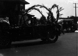 Dignitaries in decorated car in parade