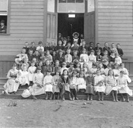 [A class on the steps of East School on Oppenheimer Street (522 East Cordova Street)]