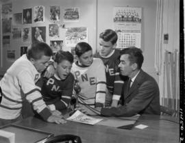 Boys in P.N.E. hockey jerseys being interviewed