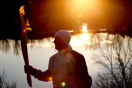 Day 36 Torchbearer 118 Phillippe Reitz runs the flame at sunset in Vallée-Jonction, Quebec.