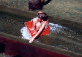 [Boy on water slide]
