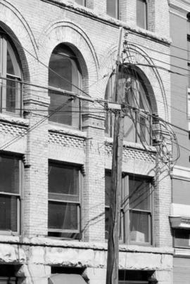 [Detail of upper level pilasters and windows at 311 Water Street]