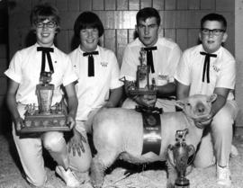 Award winning 4-H club members posing with sheep