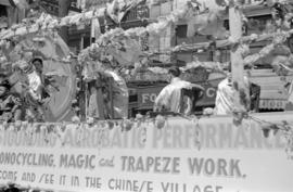 [A float of acrobats in a parade in Chinatown]