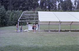 Group of men installing event tent