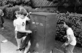 Jasmine Gibbons, Troy Zwolinski and David LeBrun clean graffiti off mailbox