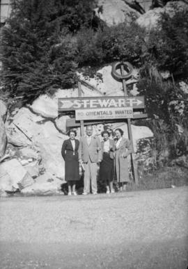 Halford Wilson, wife and friends at C.N.R. dock standing under sign