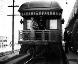 [King George VI and Queen Elizabeth standing on platform of last car of Royal Train]