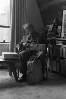 Sam Ho, age 91, holding a wrapped Christmas gift