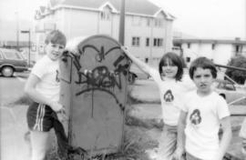 Troy Zwolinski, Jasmine Gibbons and David LeBrun clean graffiti off mailbox
