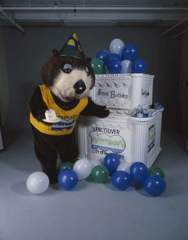 Tillicum standing beside large birthday cake