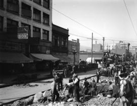 [Men excavating street at Granville and Helmcken Streets, for reconstruction of streetcar line fo...