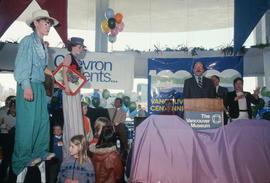 Youth on stilts during Mike Harcourt's speech at Vancouver's 99th birthday celebration