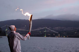 Day 105 Torchbearer 20 Turner Seward carries the flame in Stanley Park, British Columbia.