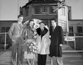 [Group portrait of three men and a woman, probably figure skaters for the Rotary Ice Carnival hol...