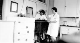 [Miss Mabel Malcolm and Miss Gertrude Dowsley working in a laboratory at Vancouver General Hospital]