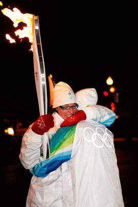 Day 35 Torchbearers exchange a hug before passing the flame in Quebec.