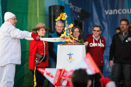 Day 100 Torchbearer 44 Bob Sheridan lights the cauldron on stage at Lillooet's Community Celebrat...