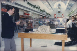 Mike Harcourt beside display case