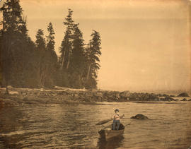 [Hugh Matthews paddling a canoe off Second Beach in Stanley Park]