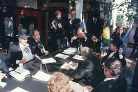 Mike Harcourt speaking into telephone during reenactment of Vancouver's first City Council meetin...