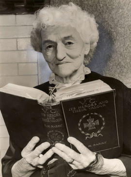 Mrs. Selina Demers holding a book containing all Victoria Cross winners